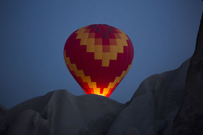 Low angle view of hot air balloon against clear blue sky