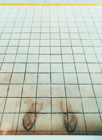 Low section of man on tiled floor