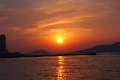 Scenic view of sea against orange sky