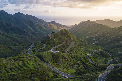 Aerial view of road amidst mountains against sky