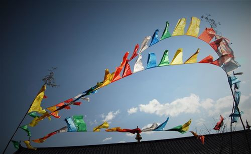 Low angle view of flags against sky