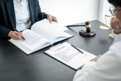 Midsection of doctor working in office