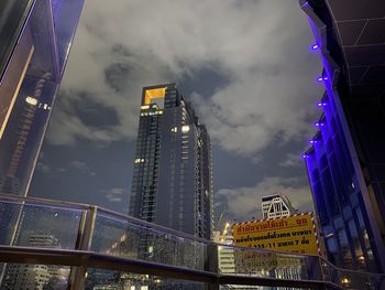 Low angle view of illuminated buildings against sky at night