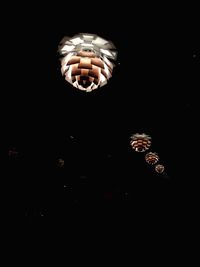 Close-up of illuminated light bulb against black background