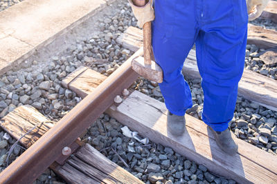 Low section of man working on railroad track