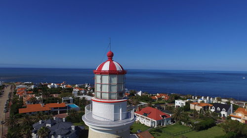 High angle view of buildings by sea against clear sky