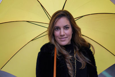 Portrait of young woman with umbrella