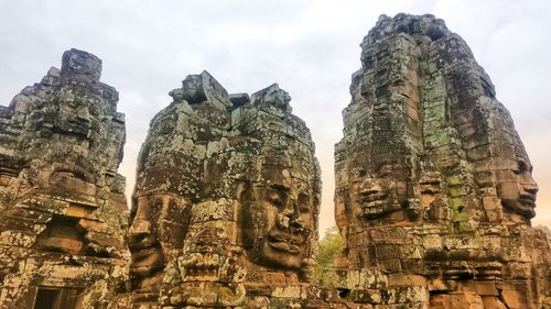 Low angle view of statue against temple against sky