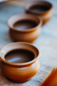 Close-up of bowls on wooden table