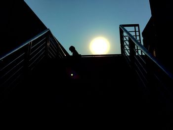 Low angle view of sun shining through clouds