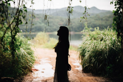 Side view of woman standing on land