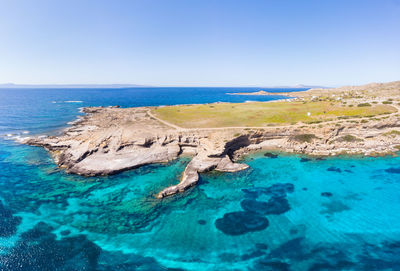 Scenic view of sea against clear blue sky