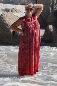 Portrait of young woman standing on rock