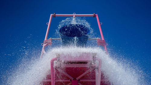 Splash water against blue sky