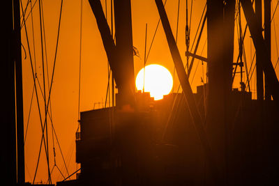 Silhouette sailboat against sky during sunset