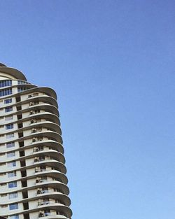 Low angle view of building against clear blue sky