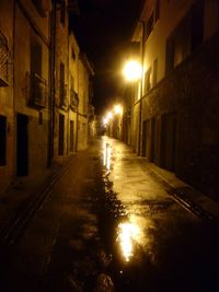 Illuminated street lights in city at night