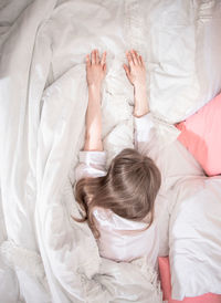 High angle view of baby sleeping on bed