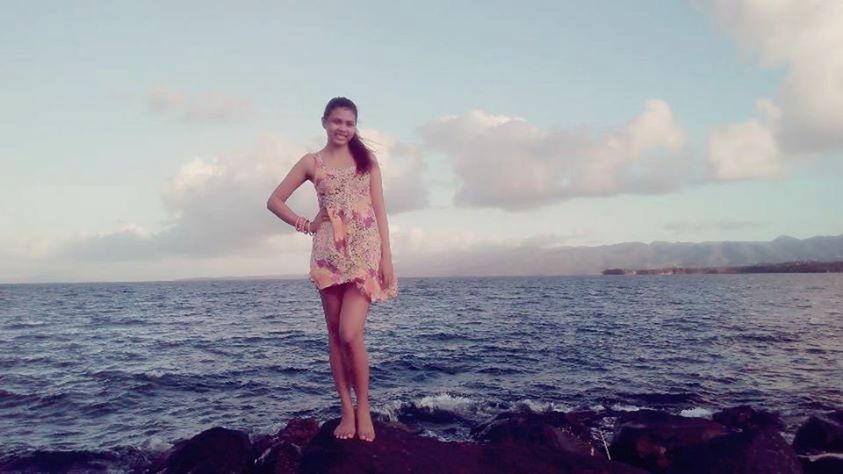 water, sea, young adult, lifestyles, person, sky, full length, leisure activity, standing, young women, horizon over water, casual clothing, looking at camera, beach, front view, three quarter length, vacations, portrait