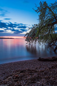 Scenic view of lake against sky during sunset