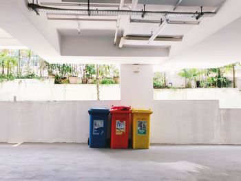 Garbage can against building