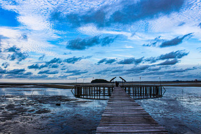 Pier over sea against sky.