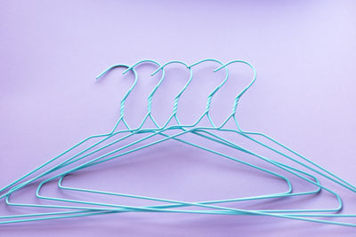 Hangers for clothes on purple background