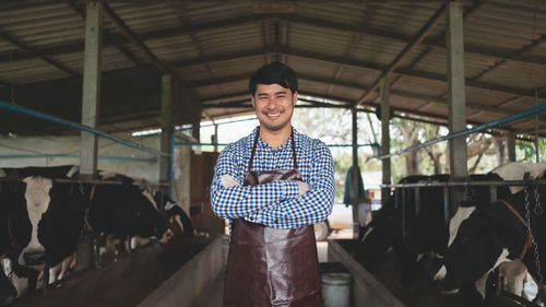 Portrait of young man standing in factory