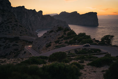Scenic view of landscape against sky during sunset with cars. formentor, mallorca, spain. 
