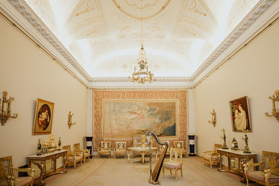 Empty chairs and tables in corridor of building