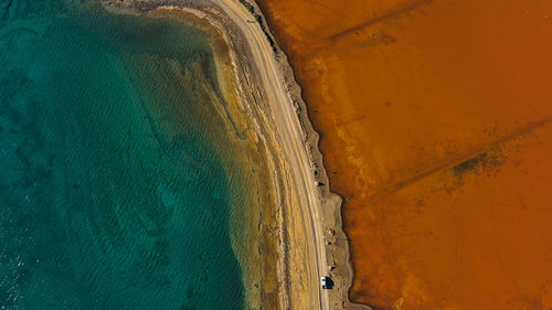 Road between sea and red salt lake.viotia, greece.
