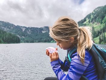 Portrait of woman drinking water in mountains