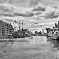 Boats in river with buildings in background