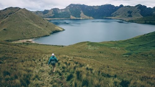 Rear view of woman walking on landscape