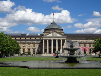 View of fountain in city against sky