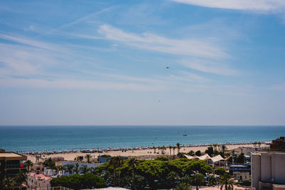 High angle view of buildings by sea against sky