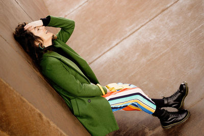 High angle view of woman sitting on floor