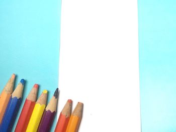 Close-up of colored pencils against white background