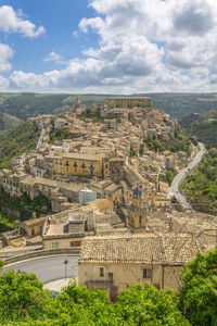 High angle view of townscape against cloudy sky, ragusa ibla