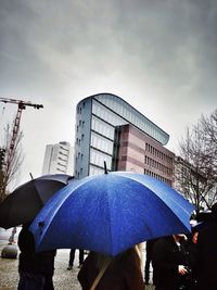 Buildings in city against cloudy sky