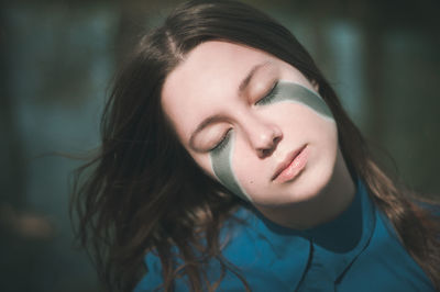 Close-up of young woman with eyes closed