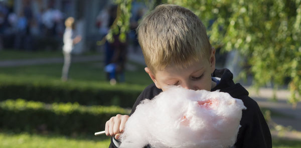Close-up of boy eating cotton candy