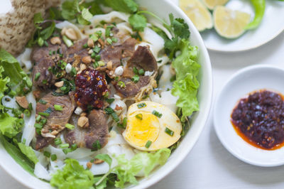 Vietnamese noodle - my quang, vietnamese traditional cuisine, noodles in bowl on the table 