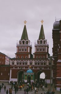 People in front of building against sky