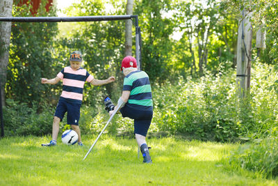 Boy playing football in garden