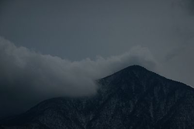 Scenic view of mountains against cloudy sky