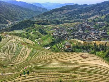 Scenic view of rice field against mountains