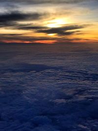 Scenic view of sea against dramatic sky during sunset