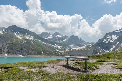 Scenic view of mountains and lake against cloudy sky