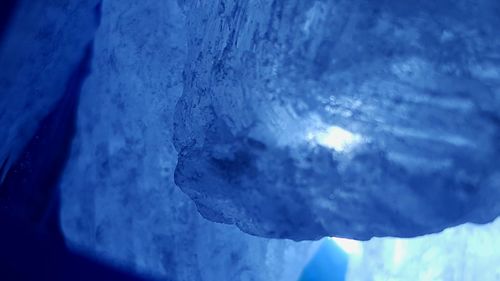 Close-up of snow against blue sky